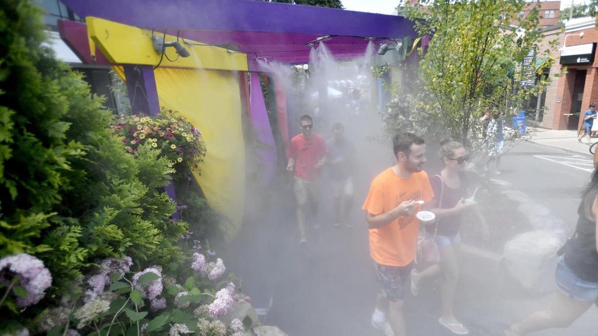 Visitors cool off in the mister along South Allen Street during the 2016 Central Pennsylvania Festival of the Arts.