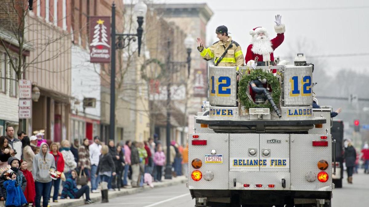 Riding atop a Reliance Fire Company truck, Santa waves to the youngsters along Front Street during the Philipsburg Kickoff to Christmas parade in 2015.