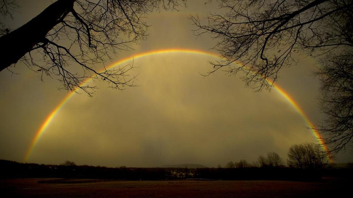 A full rainbow arches over Tom Tudek Memorial Park with Mount Nittany below in State College in February.