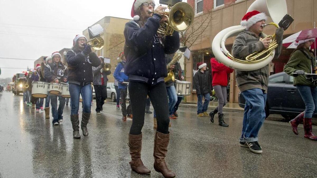 The Philipsburg-Osceola Area High School marching band plays down Front Street during the 2014 holiday parade.