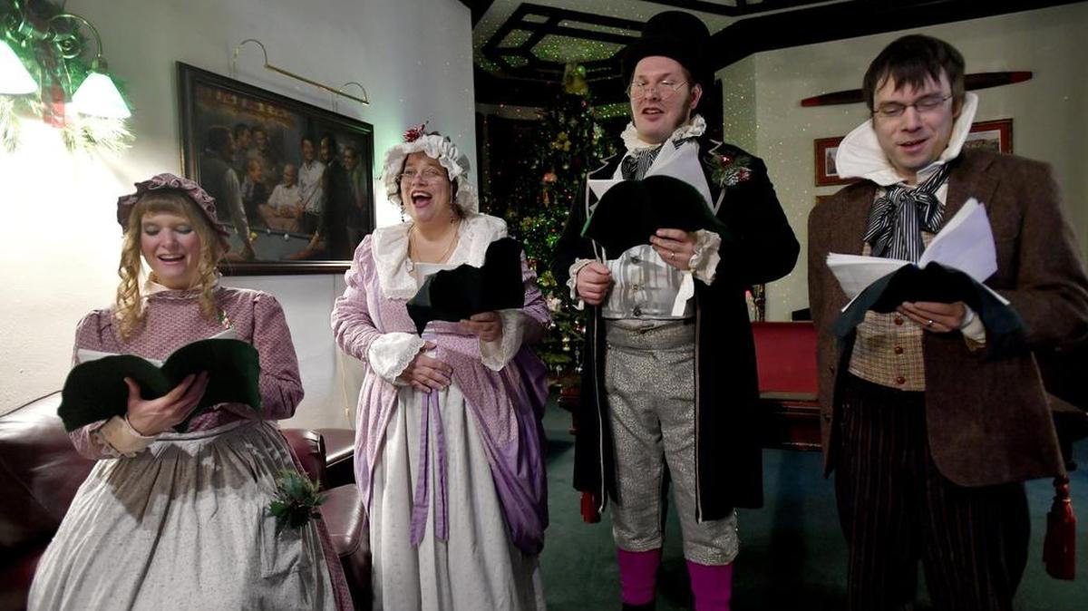 Characters from the Dickens Troupe sing carols during high tea at the Reynolds Mansion during the 2016 Bellefonte Victorian Christmas.