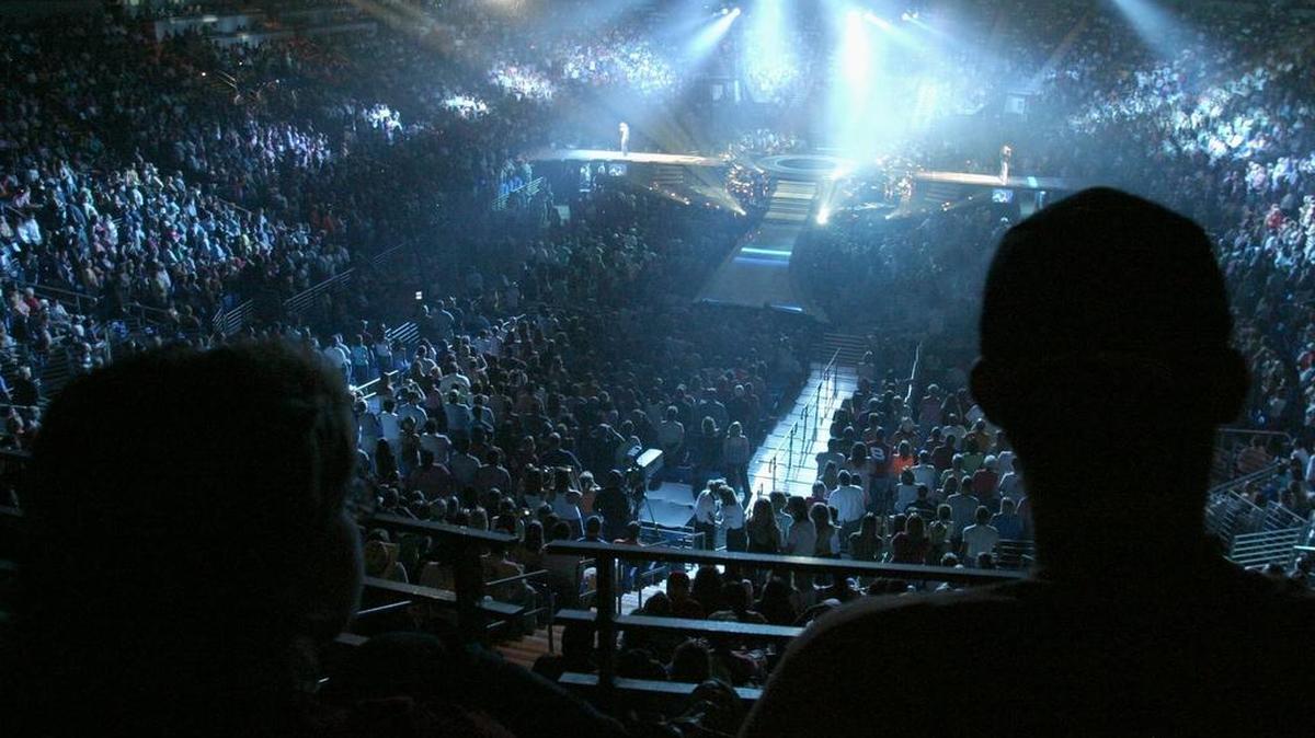 Fans listen to Tim McGraw and Faith Hill’s opening song, Like We Never Loved At All, at the Bryce Jordan Center in 2006.