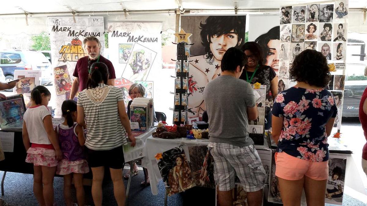 Festival attendees look over the wares of vendors at the 2016 BookFest.