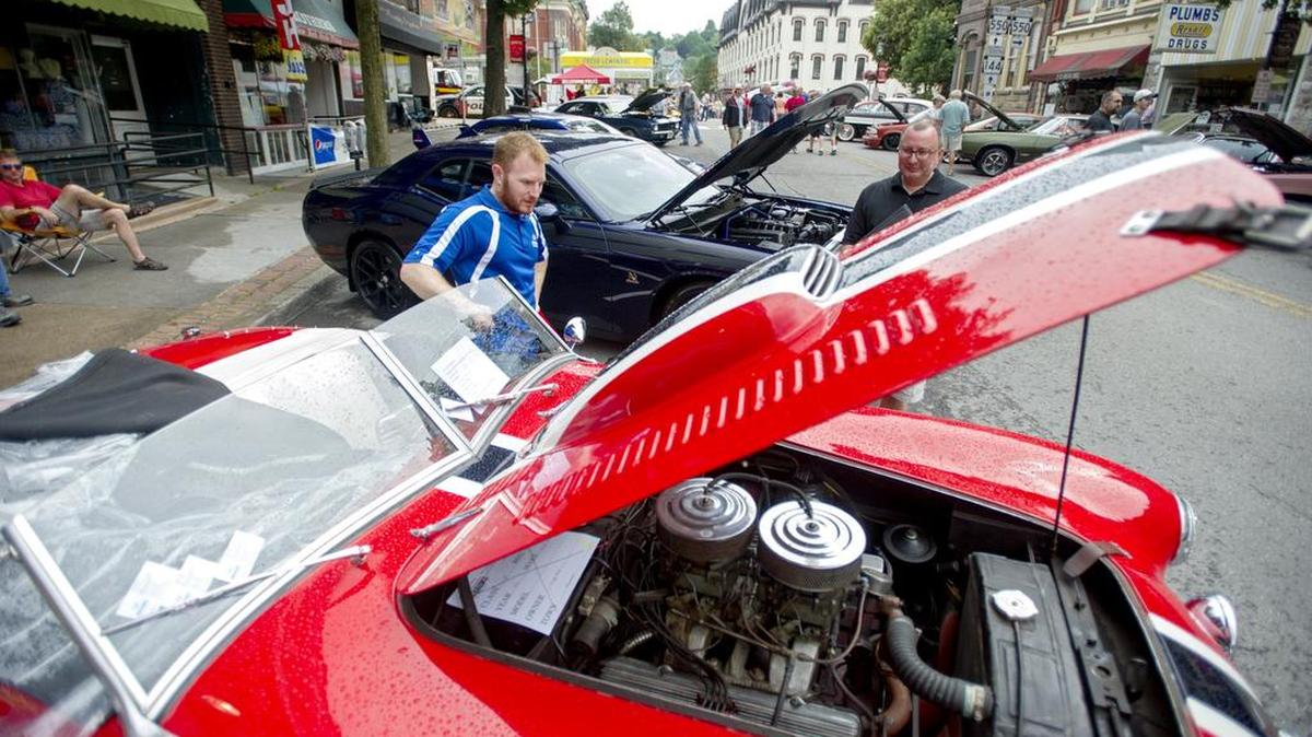 Joseph Zolna revs the engine of his 1953 Allard K3 Roadster for admirers during the 2015 Bellefonte Cruise.