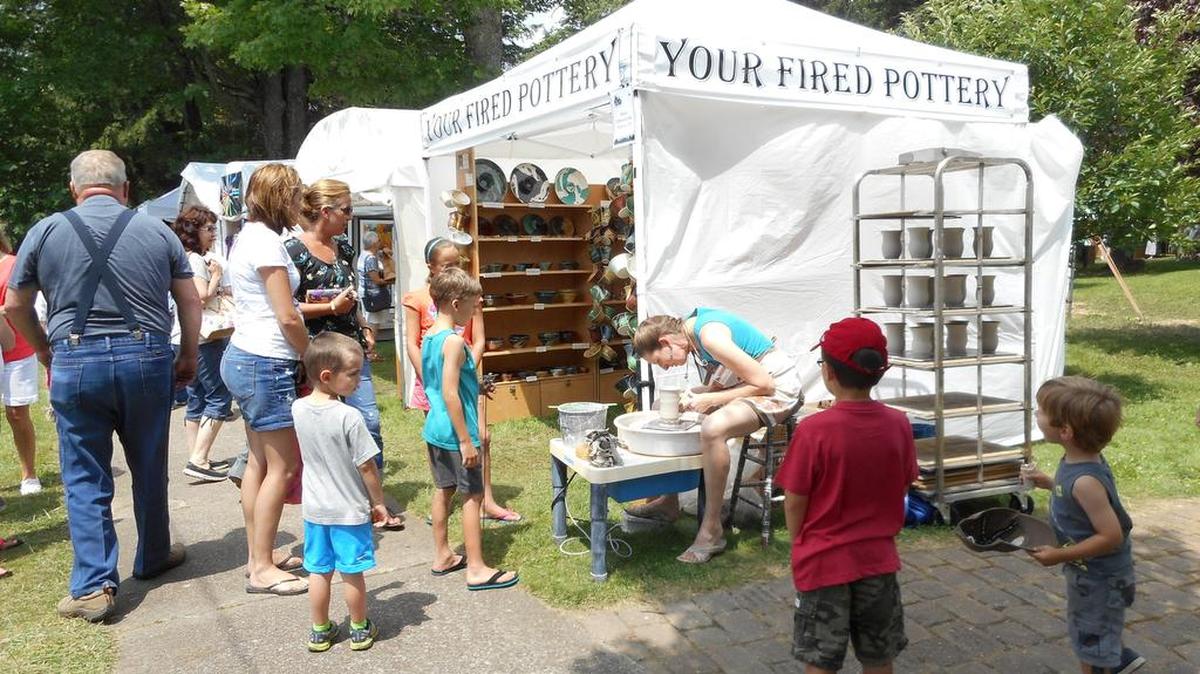 Stacie Johnson-Leske demonstrates potting at her booth during Art in the Wilds.