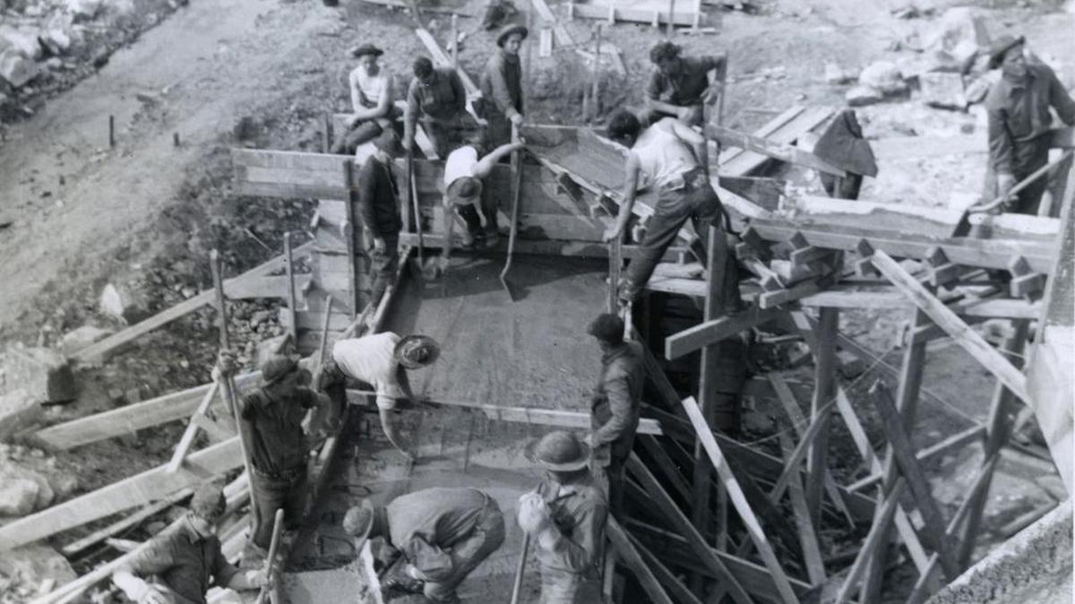Civilian Conservation Corps workers pour concrete for the Poe Valley dam. The CCC camps helped to build Poe Valley State Park during the Great Depression.