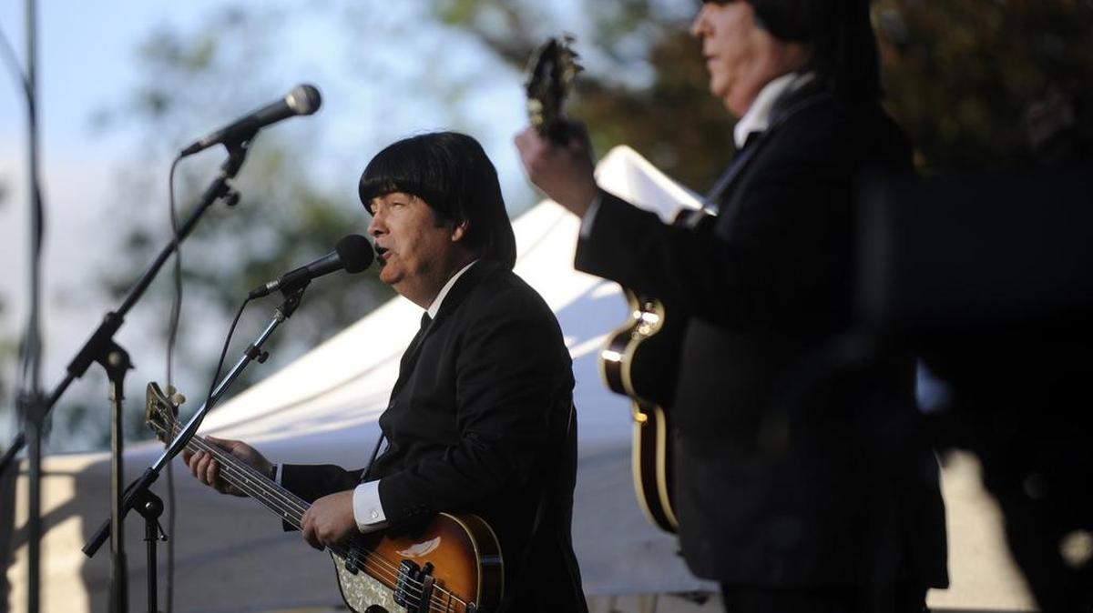 The Cast of Beatlemania performs on the Old Main lawn in August 2013.
