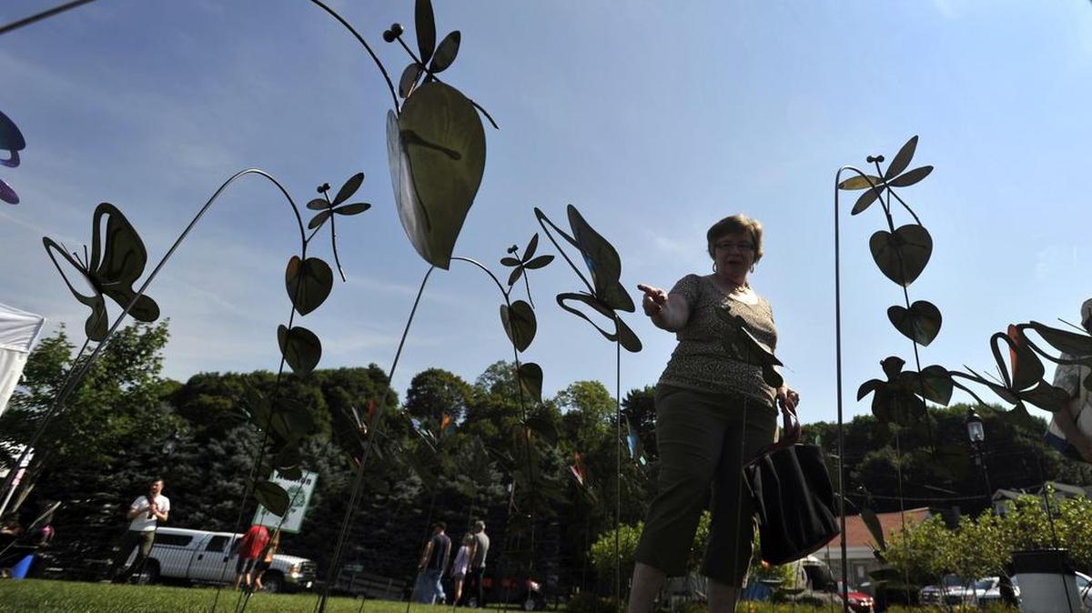 Karen Parvin of Hollidaysburg looks at Jerry Cole’s steel yard art at the 2015 Bellefonte Arts & Crafts Fair.