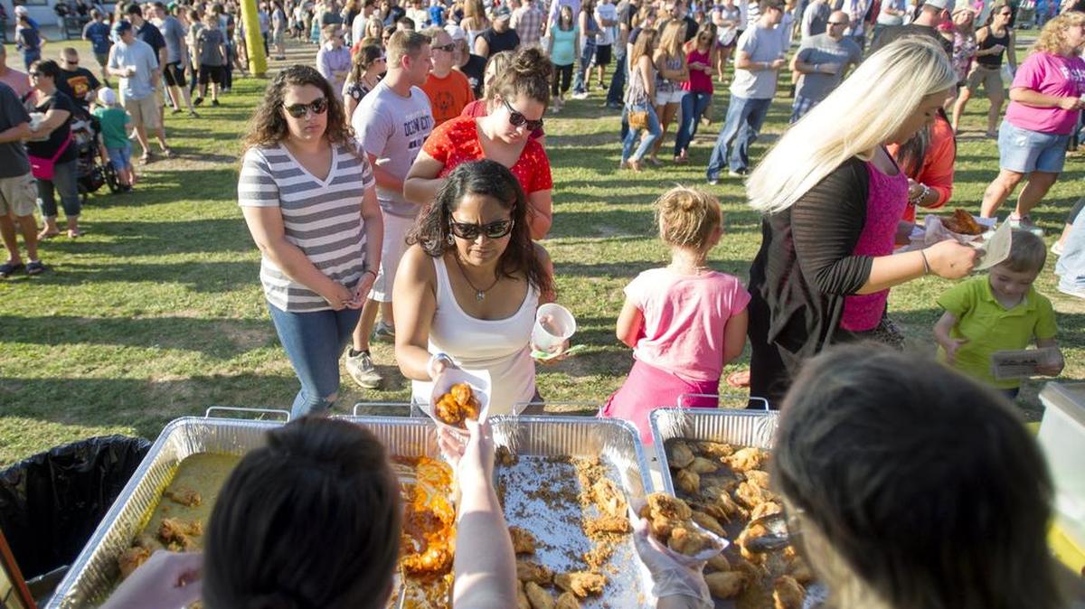 Visitors wait in line to get wings from Village Eating House Artisan Foods in 2015 at Tussey Mountain WingFest.