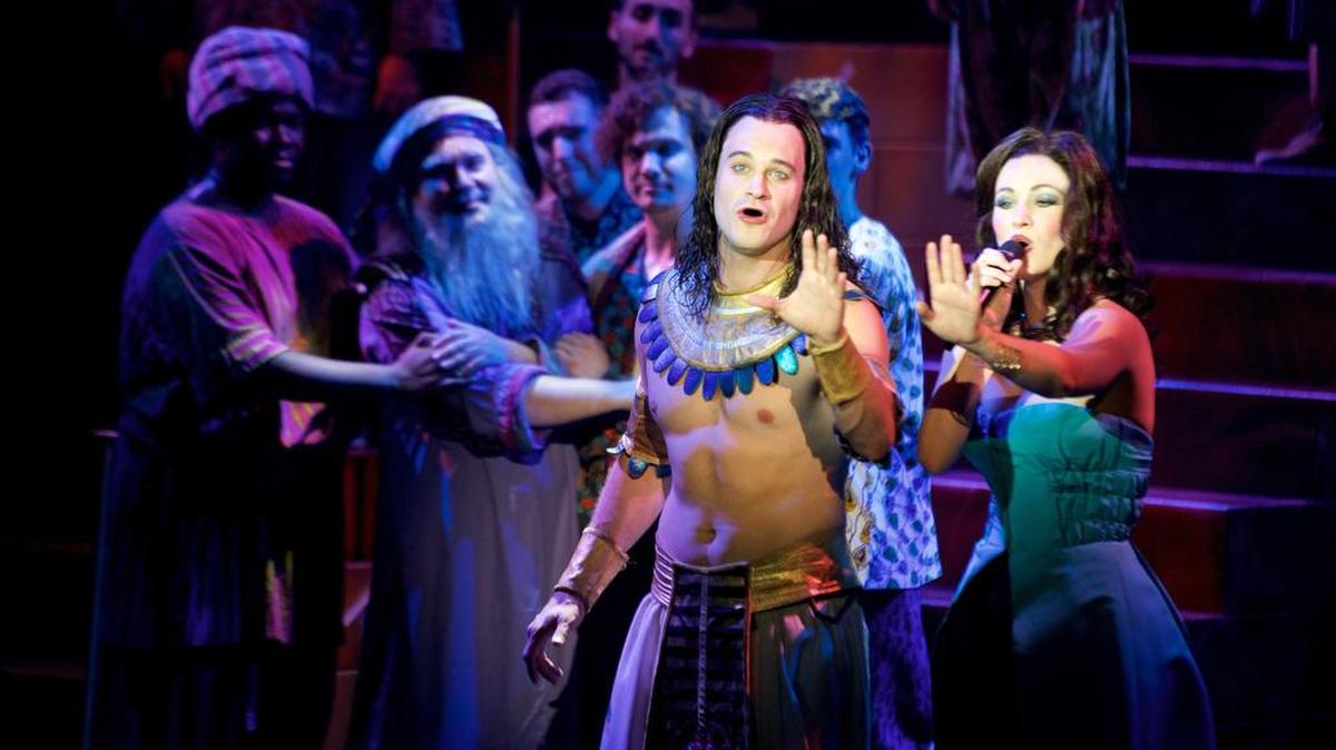 JC McCann stars as Joseph, left, and Laura Helm as the narrator in the Broadway touring production of “Joseph and the Amazing Technicolor Dreamcoat.”