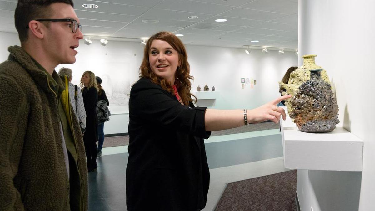 Artist Rebecca Morgan and Andy Grabysiak have a conversation by Morgan's Face Jugs at the Woskob Family Gallery.
