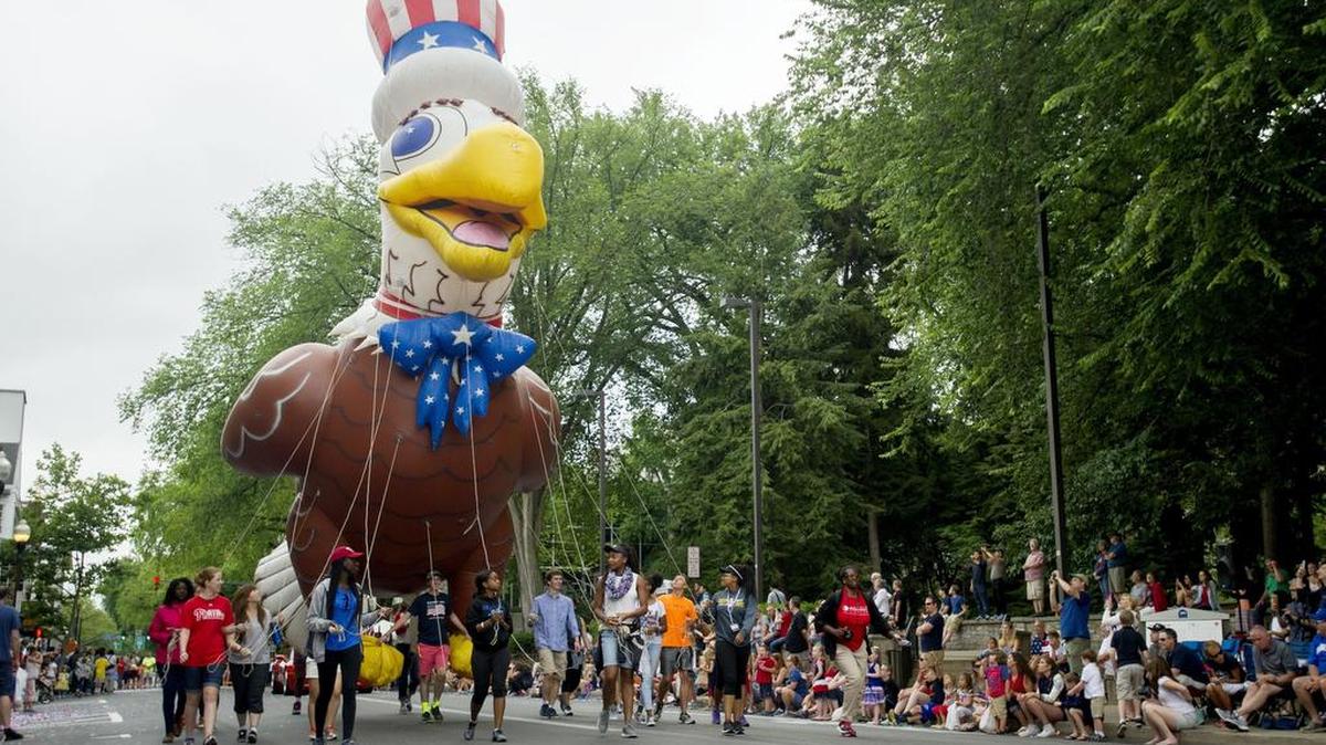 A balloon eagle makes its way down College Avenue during the 2016 4th Fest Heroes Parade.
