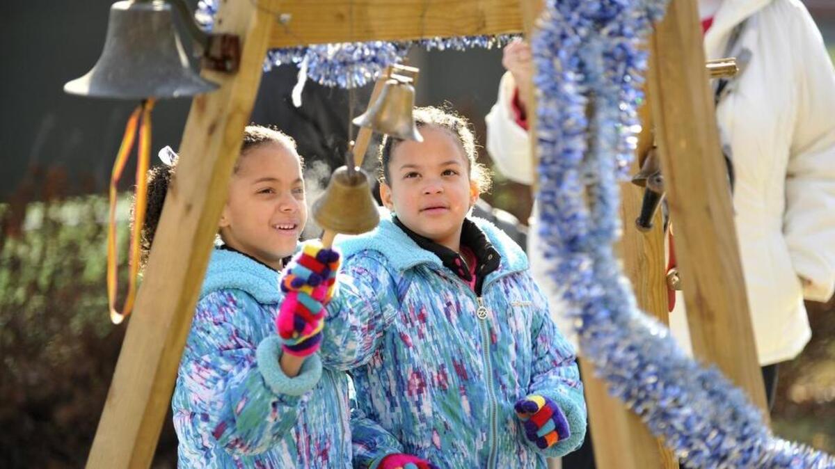 Twins Nyla, left, and Jayla Williams ring the New Year’s bells in Sidney Freedman Park in 2014 during First Night State College.
