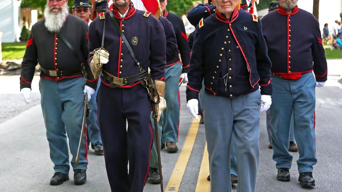 Members of Boalsburg Battery B march down Church Street as part of the 2016 Memorial Day ceremony.
