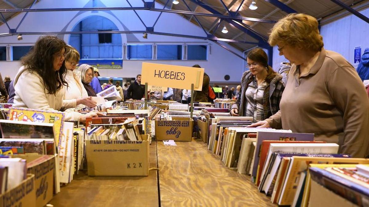 Customers browse in the hobbies section of the 2016 AAUW Used Book Sale at the Snider Agricultural Arena.