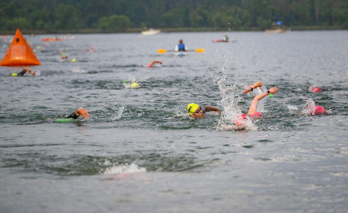 Athletes approach the end of the 1.2 mile swim in Foster Joseph Sayers Lake at Bald Eagle State Park for the Ironman 70.3 Pennsylvania Happy Valley on Sunday, June 30, 2024.