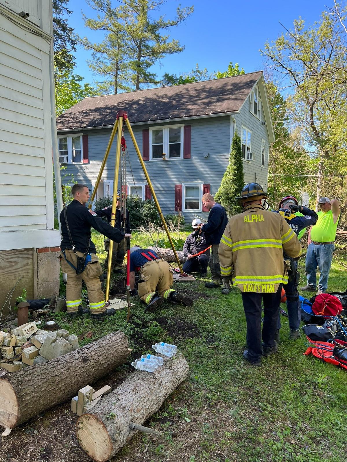 Alpha Fire Company firefighters work to rescue a corgi who fell into a sinkhole in College Township on Wednesday, May 11, 2022.