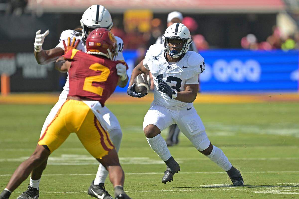 Oct 12, 2024; Los Angeles, California, USA; Penn State Nittany Lions running back Kaytron Allen (13) runs for a short gain in the first half against the USC Trojans at United Airlines Field at the Los Angeles Memorial Coliseum. Mandatory Credit: Jayne Kamin-Oncea-Imagn Images