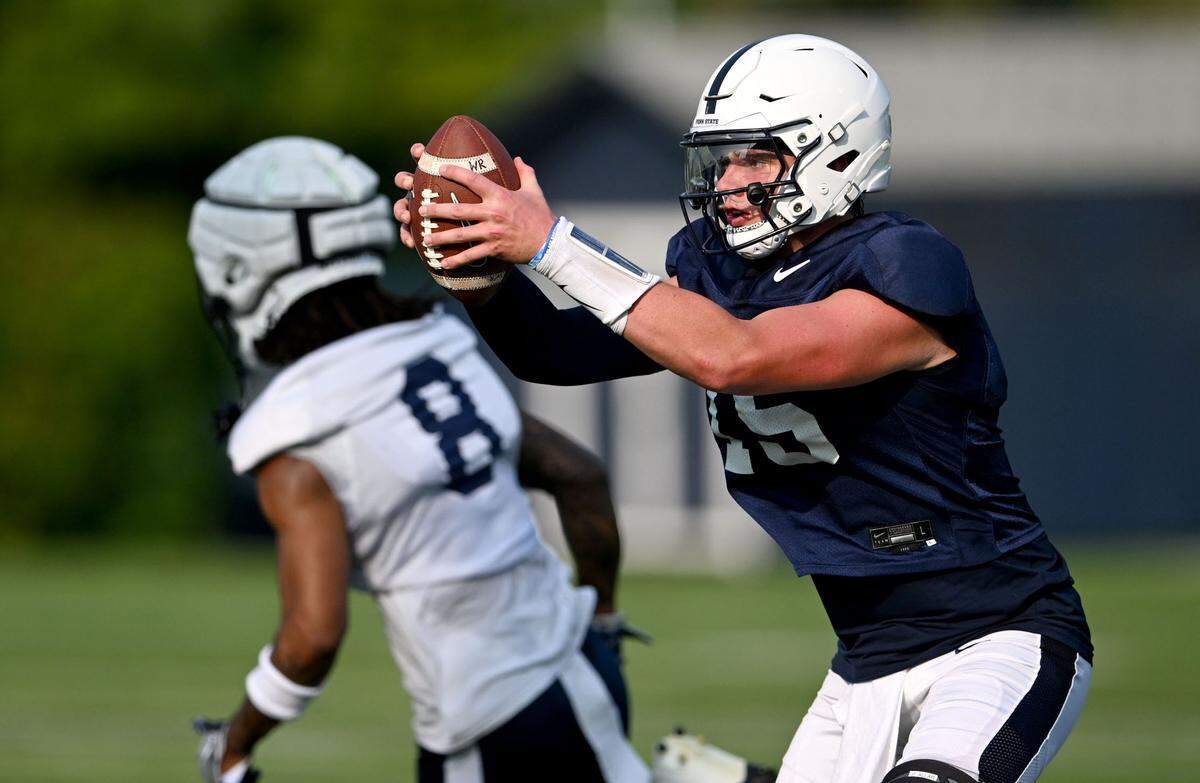 Penn State quarterback Drew Allar gets the snap to run a drill at practice on Wednesday, July 31, 2024.