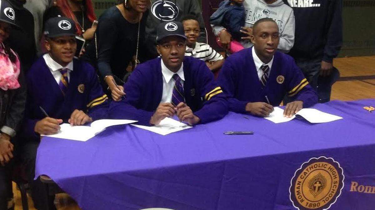 Philadelphia Roman Catholic High School basketball standouts, from left, Lamar Stevens, Tony Carr and Nazeer Bostick sign National Letters of Intent on Wednesday night at their high school to enroll at Penn State and join the Nittany Lions. 
