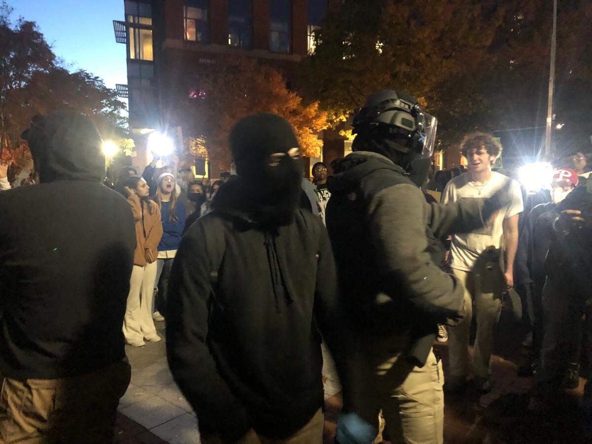Several men dressed in black with their faces covered agitated the crowd gathered on Monday, Oct. 24, 2022 to protest an event featuring the founder of the Proud Boys.