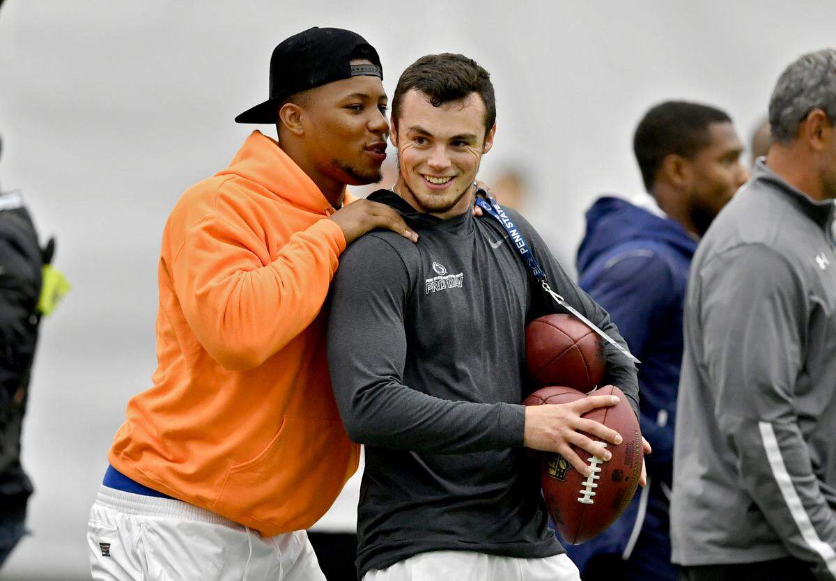 NFL rookie of the year Saquon Barkley hugs friend Trace McSorley after McSorley threw for NFL personnel during Pro day on Tuesday, March 19, 2019 at Holuba Hall.