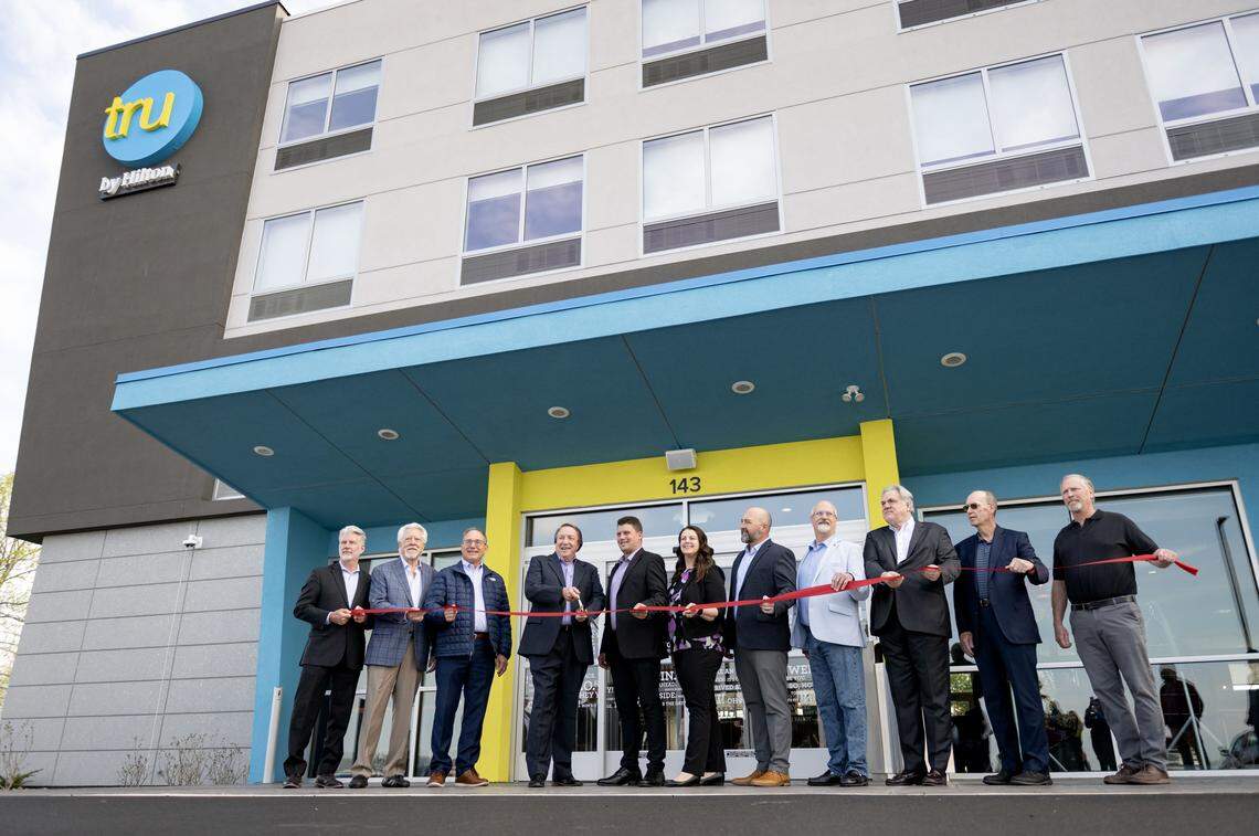 Edward Tubbs, CEO of Hospitality Asset Management Company, cuts the ribbon for the new Tru Hotel by Hilton on Benner Pike on Wednesday, April 22, 2026.  