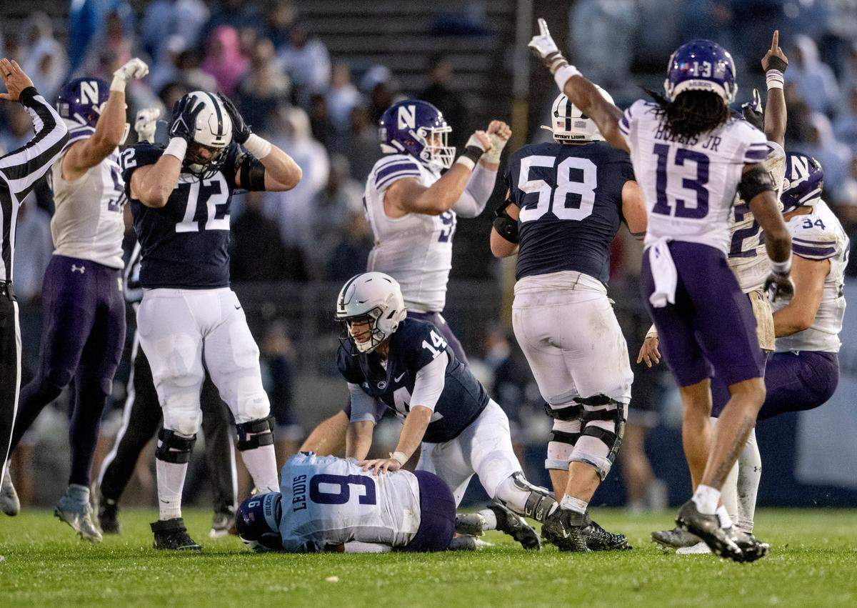 Players react as Northwestern’s Jeremiah Lewis recovers a Penn State fumble during the game on Saturday, Oct. 1, 2022.