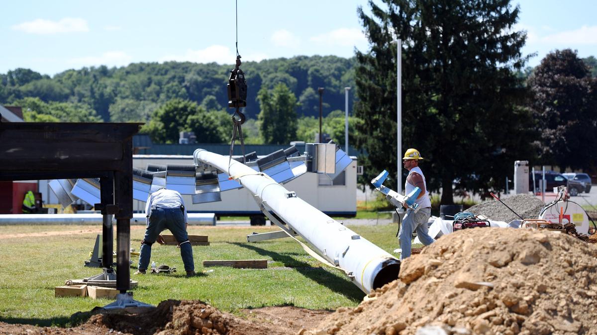 Workers install the stadium lights for Bellefonte's Rogers Stadium Thursday, July 19, 2018 at Bellefonte Area High School.
