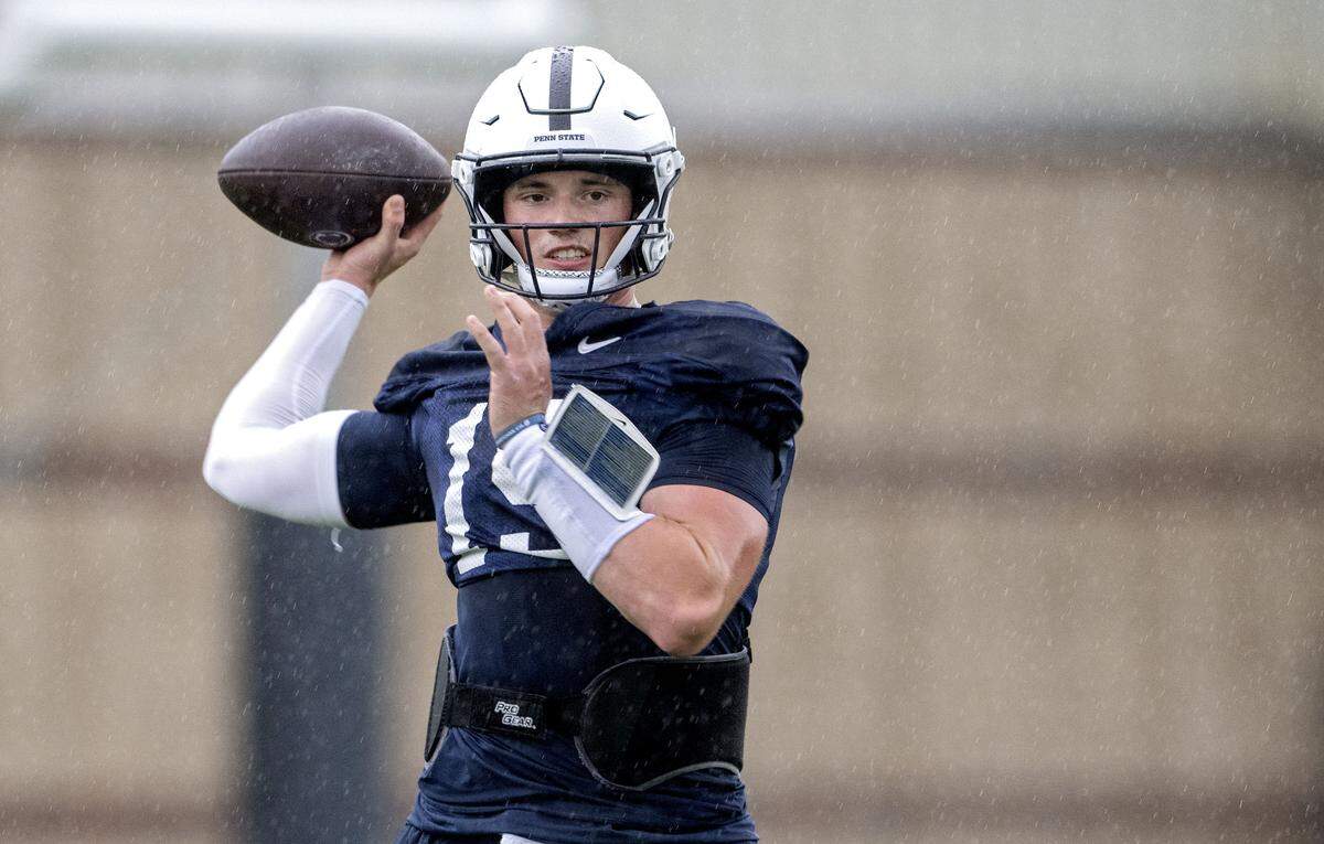 Penn State quarterback Drew Allar makes a pass during practice in the rain on Wednesday, Sept. 24, 2025.  
