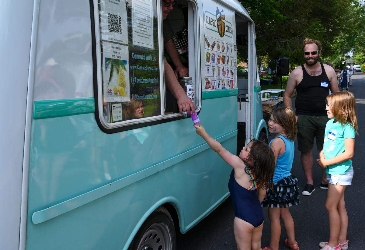 Kids flock to the Classic Cones ice cream truck during the Overlook Heights neighborhood block party on June 20.