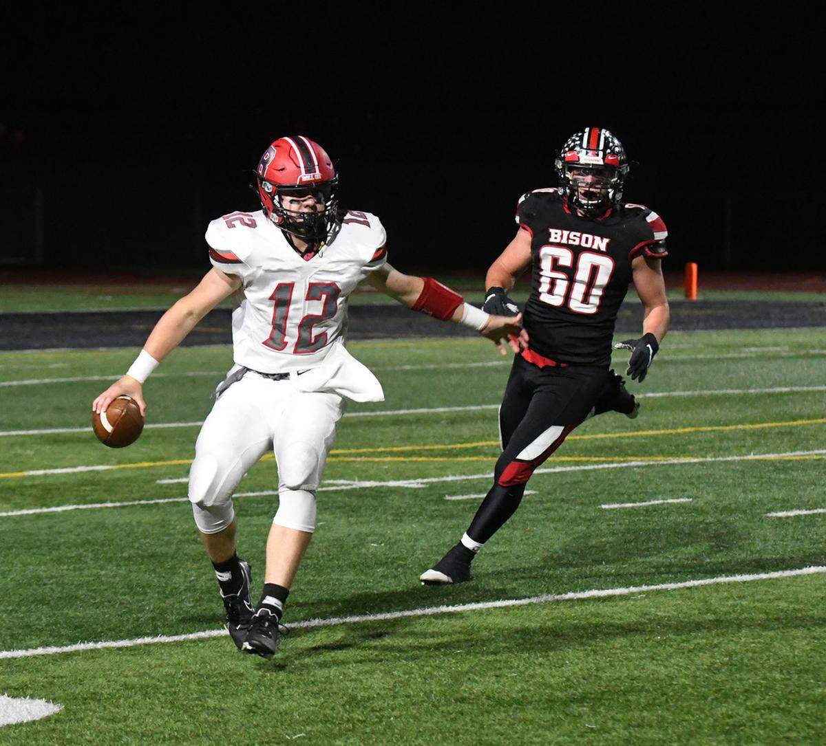 Bellefonte quarterback Trevor Johnson is pursued by Clearfield’s Hayden Kovalick on Friday night.