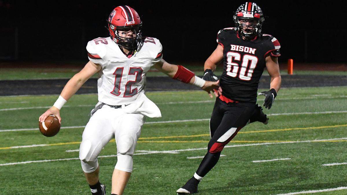 Bellefonte quarterback Trevor Johnson is pursued by Clearfield’s Hayden Kovalick on Friday night.