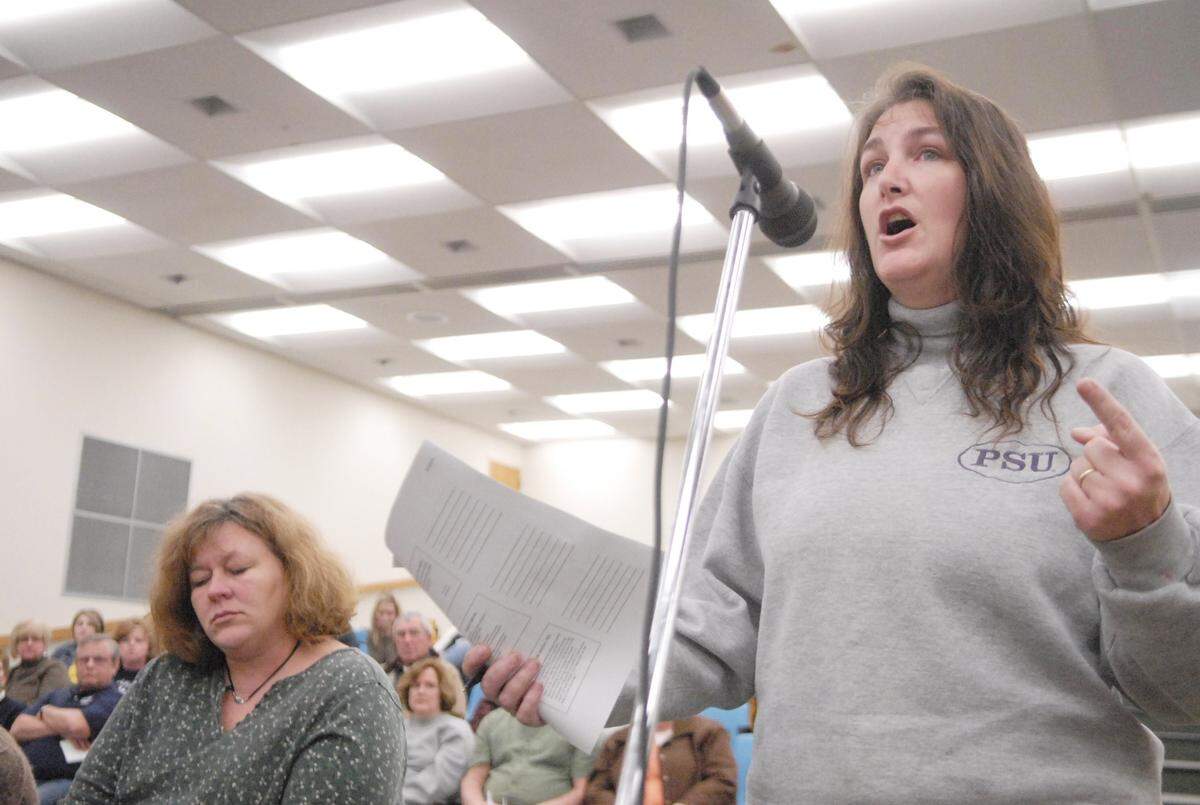 Pamela Hackenburg, right, at a Mifflinburg Area School Board meeting in 2011. Hackenburg has been charged by Pennsylvania State Police related to the theft of almost $533,000 from Gregg Township, Centre County.