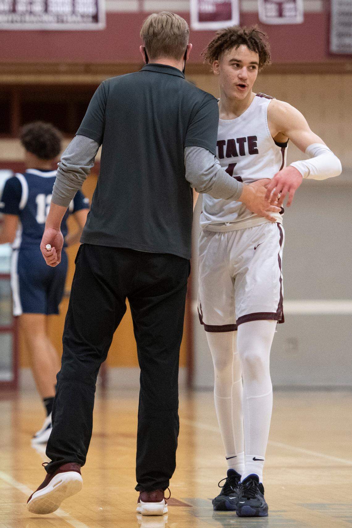 State College’s Braeden Shrewsberry hugs head coach Brian Scholly during a PIAA basketball game between State High and Chambersburg at the State High gym on Tuesday.