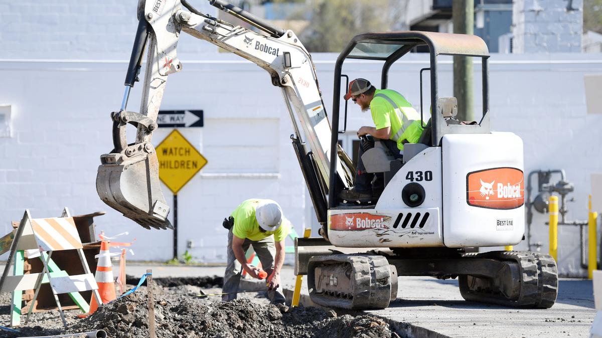 Kyle Sipes, right, digs for curb while Fred Neff helps lay out the curb while working on construction on a parking lot Monday, April 30, 2018 in Bellefonte.