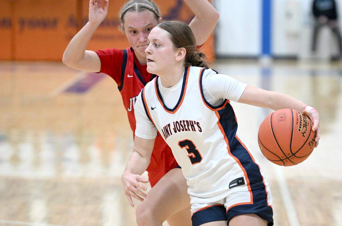 Saint Joseph’s Catholic Academy’s Naomi Crispin dribbles around a Juniata defender during the game on Thursday, Jan. 23, 2025. Saint Joseph’s Catholic Academy won, 72-34.