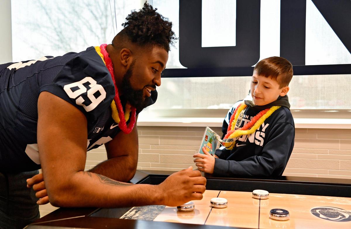 Penn State offensive lineman C.J. Thorpe and Daniel Testa 11, strategize as they play a round of table shuffleboard at the Lasch Building on Saturday, Feb. 22, 2020.