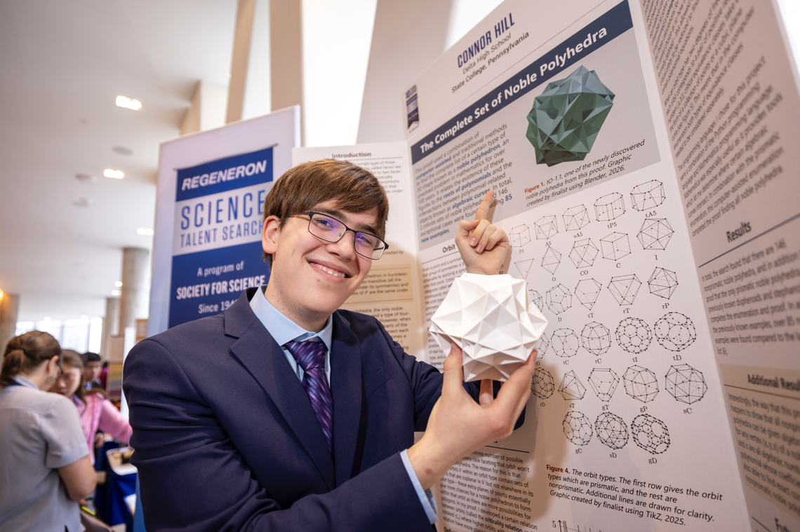 Connor Hill poses with a model of a noble polyhedron while showing off his award-winning research.