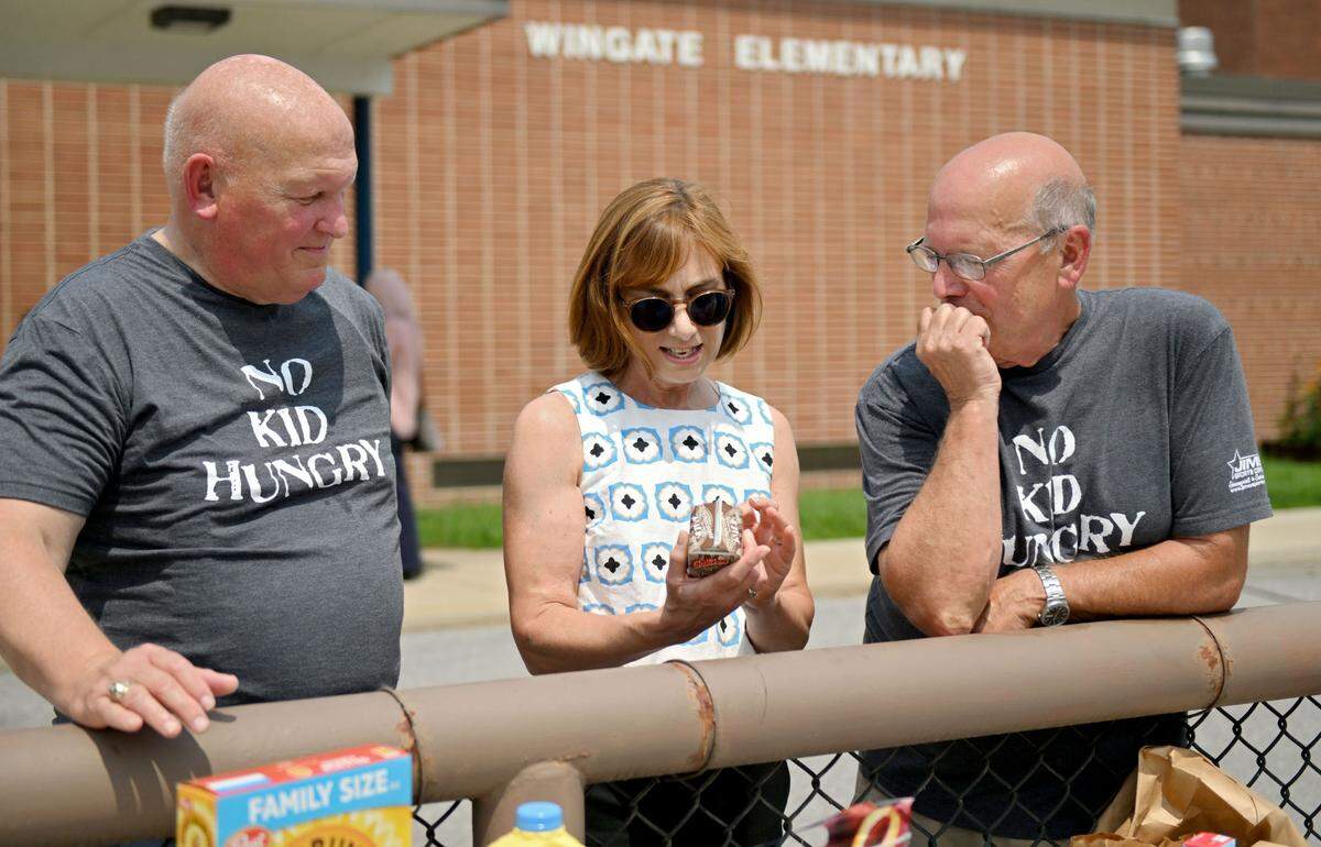 U.S. Rep Glenn “GT” Thompson, Deputy Under Secretary Cindy Long of the USDA and Mel Curtis from the Centre County YMCA talk about local milk products being handed out during a Summer Meals Distribution outside of Wingate Elementary School on Monday, Aug. 5, 2024.
