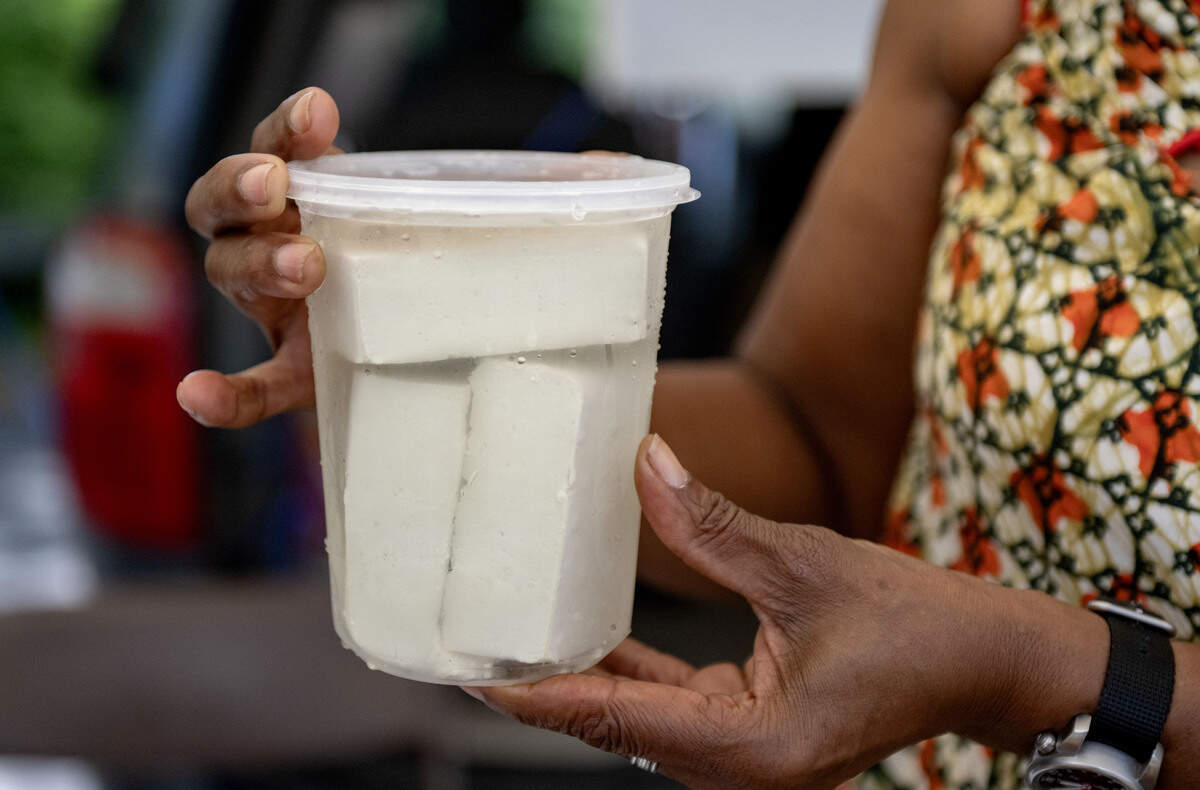 Yasoda Mensah holds a container of her fresh Trifolia Tofu at the Boalsburg Farmers Market on Tuesday, June 23, 2026. Mensah makes the tofu Monday from organic homegrown soy beans.