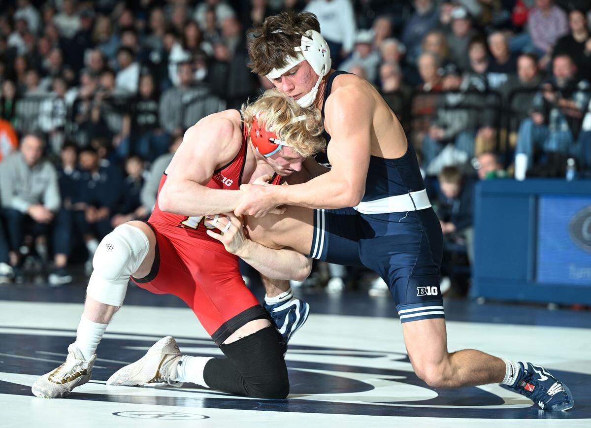 Penn State’s Tyler Kasak fights off Maryland’s Ethen Miller at 157 lbs. during Sunday’s meeting at Rec Hall in State College. Kasak lost by injury default.
