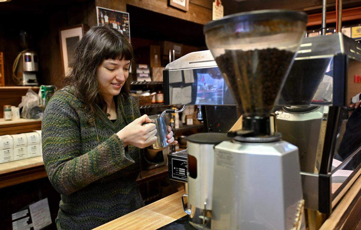 Zoe Ellis steams the milk for a hot chocolate at The Cheese Shoppe on Monday, Feb. 10, 2025.