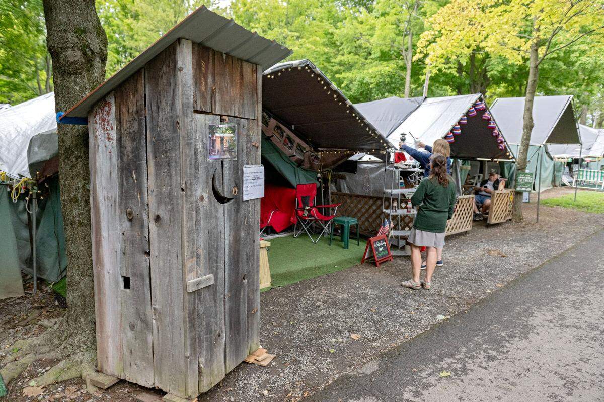 An outhouse outside of the Rogers family tent honors their decoration themes over the years at the Centre County Grange Encampment and Fair.
