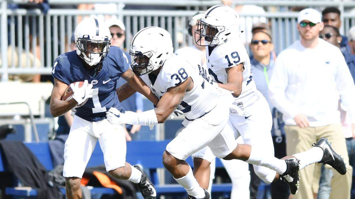 Penn State safety Lamonte Wade forces wide receiver KJ Hamler to fumble the ball during the Blue-White game Saturday, April 21, 2018 at Beaver Stadium.