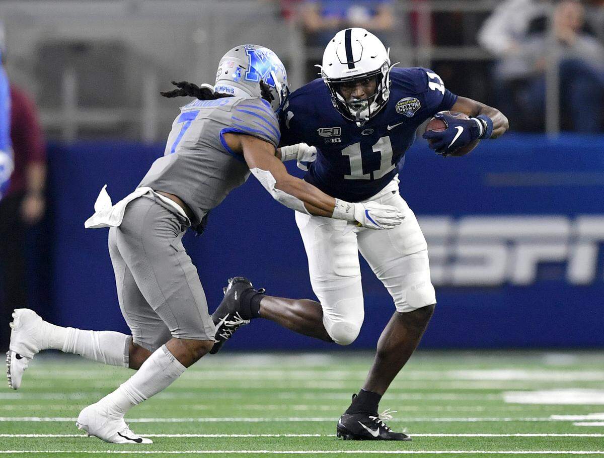 Penn State wide receiver Daniel George makes a catch and tries to cut around a Memphis defender during the 84th Goodyear Cotton Bowl Classic at AT&T Stadium in Arlington, TX on Saturday, Dec. 28, 2019.