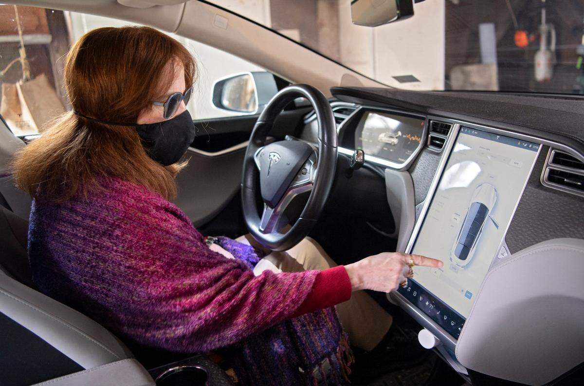 Joanne Tosti-Vasey shows some of the features in her Tesla on Thursday, Dec. 10, 2020. Tosti-Vasey was the first Tesla owner in Centre County and also uses solar panels on her home.