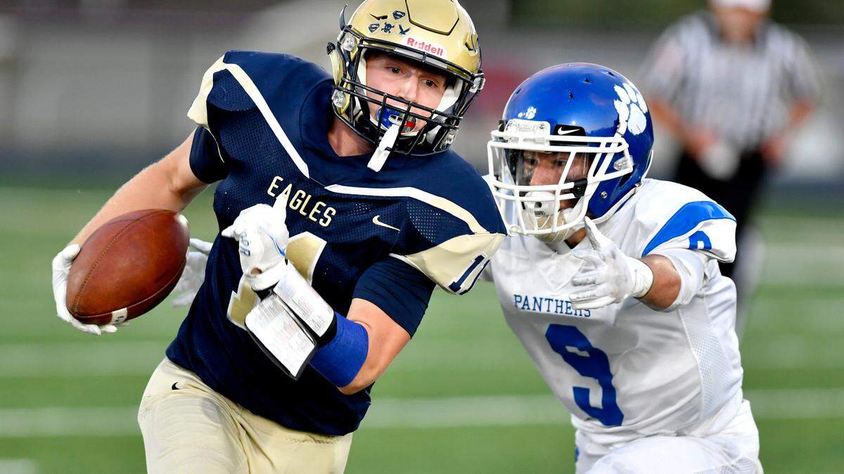North Penn-MansfieldÕs Cameron Fabian reaches for Bald Eagle AreaÕs Hayden Vaughn as she runs with the ball during the game on Friday, Sept. 10, 2021. Bald Eagle Area won, 50-7.
