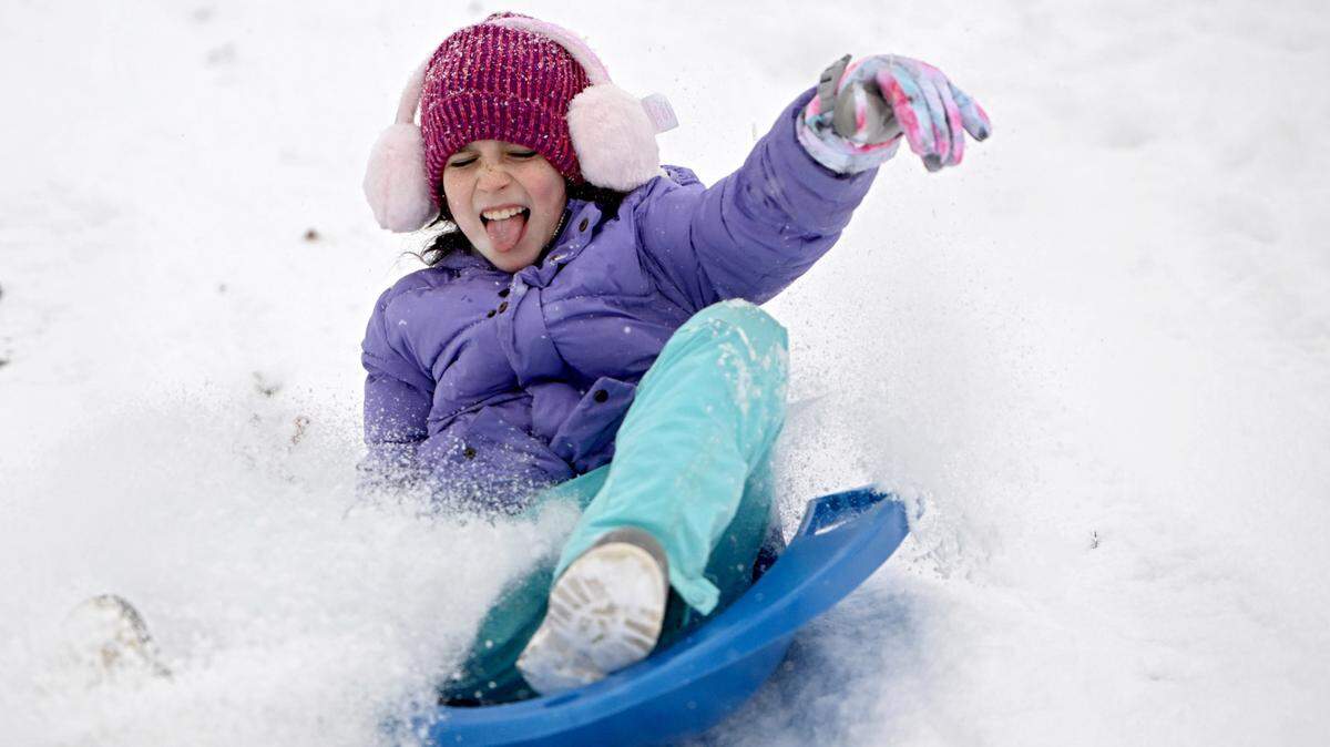 Abby Carroll sleds in her front yard after several inches of snow fell on Tuesday, Jan. 16, 2024.