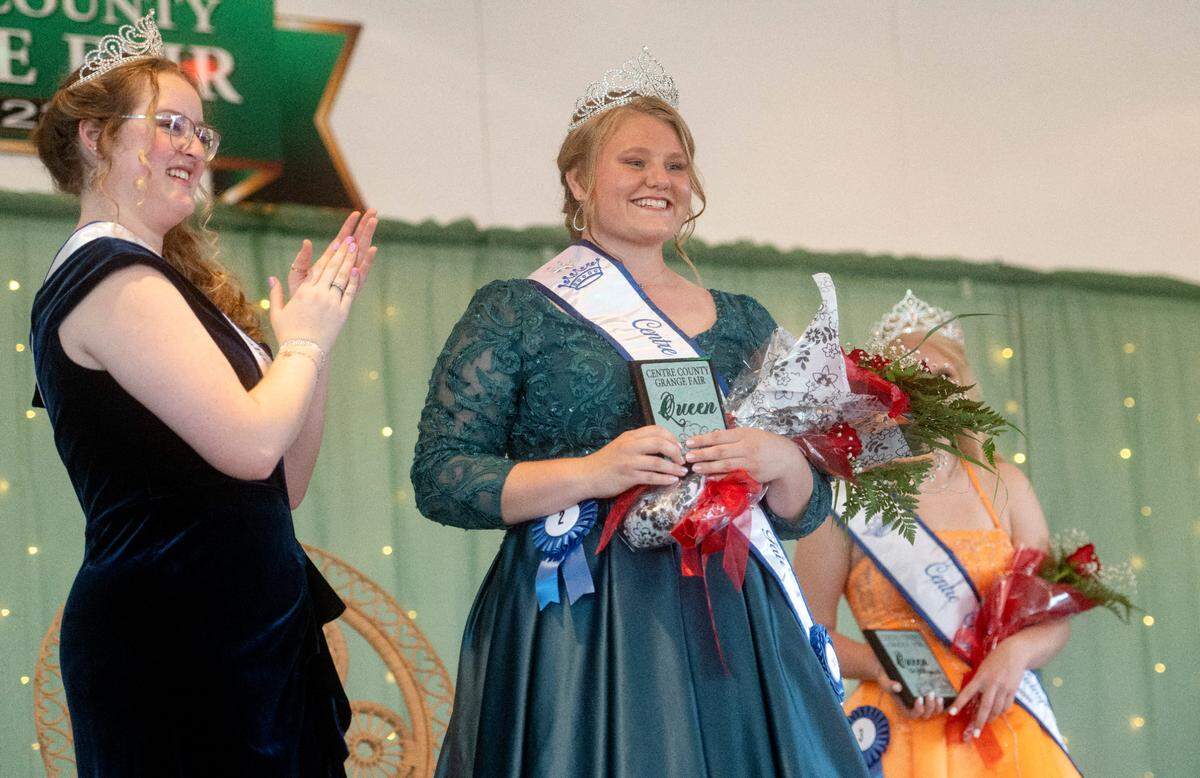 Outgoing queen Ella Smith applauds Teaghan Bair after she was crowned the 2023 Centre County Grange Fair Queen on Wednesday, Aug. 16, 2023.
